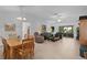 Spacious living room with tile floors, comfortable seating, and sliding glass doors to the lanai at 1813 Caryle Ln, The Villages, FL 32162