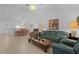 Open-concept living room featuring tile flooring, comfortable seating, and natural light at 1813 Caryle Ln, The Villages, FL 32162