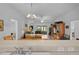 Open-concept living space features tile floors and view of living room and kitchen area at 1813 Caryle Ln, The Villages, FL 32162