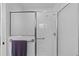 A clean and modern shower with a glass door, towel bar and accessible grab bar for convenience at 1813 Caryle Ln, The Villages, FL 32162