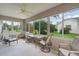 Inviting sunroom with bright windows, comfortable seating, and charming views of the landscaped backyard at 1813 Caryle Ln, The Villages, FL 32162