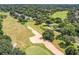 Breathtaking aerial view of the golf course with lush fairways and mature trees at 1930 Farmington Ct, Clermont, FL 34711