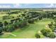 Expansive aerial view of a golf course community featuring lush landscaping and picturesque views at 1930 Farmington Ct, Clermont, FL 34711