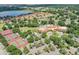 Beautiful community featuring tennis courts, pool, clubhouse, and mature landscaping, as seen from the air at 1930 Farmington Ct, Clermont, FL 34711