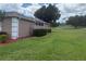 Private backyard with lush green grass, and views of the golf course at 1930 Farmington Ct, Clermont, FL 34711