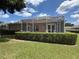 The backyard features a screened-in lanai and well-maintained landscaping for outdoor enjoyment at 1930 Farmington Ct, Clermont, FL 34711