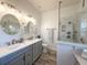 Elegant bathroom with double vanity sinks and a spacious glass-enclosed shower showcasing modern design at 1930 Farmington Ct, Clermont, FL 34711