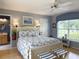Cozy bedroom featuring a beach themed design and a large window for natural light at 1930 Farmington Ct, Clermont, FL 34711