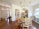 Open-concept dining area with hardwood floors, chandelier, and easy access to the kitchen and living areas at 1930 Farmington Ct, Clermont, FL 34711