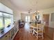 Bright dining room features hardwood floors, chandelier, and view of the backyard at 1930 Farmington Ct, Clermont, FL 34711