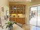 Dining room with built in china cabinet and butler's pantry area leading to the kitchen and backyard pool area at 1930 Farmington Ct, Clermont, FL 34711