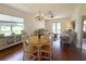 Bright dining room features hardwood floors, chandelier, and view of the backyard at 1930 Farmington Ct, Clermont, FL 34711