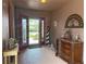Inviting entryway showcasing stained glass door, decorative furniture, and an abundance of natural light at 1930 Farmington Ct, Clermont, FL 34711