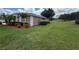 Well-maintained exterior with lush lawn and manicured landscaping and golf course view at 1930 Farmington Ct, Clermont, FL 34711