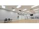 Large fitness area featuring mirrors, hardwood floors, high ceilings and plenty of natural light at 1930 Farmington Ct, Clermont, FL 34711