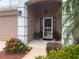 Inviting front entrance with well-maintained landscaping and a decorative doorway at 1930 Farmington Ct, Clermont, FL 34711