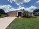 Charming single Gathering home with a well manicured lawn and landscape in a desirable community at 1930 Farmington Ct, Clermont, FL 34711