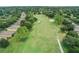 Aerial view of well-maintained golf course surrounded by trees and residences at 1930 Farmington Ct, Clermont, FL 34711