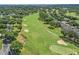 Picturesque aerial shot of the golf course showcasing lush greens, mature trees and manicured fairways at 1930 Farmington Ct, Clermont, FL 34711