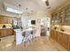 Spacious kitchen with stainless steel appliances, breakfast bar, and seamless transition to dining area at 1930 Farmington Ct, Clermont, FL 34711