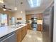 Beautifully designed kitchen featuring stainless steel appliances, light wood cabinets and backyard views at 1930 Farmington Ct, Clermont, FL 34711
