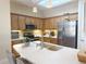 Bright kitchen featuring stainless steel appliances, wood cabinets, and a skylight with pendant lighting at 1930 Farmington Ct, Clermont, FL 34711