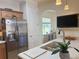 Well-lit kitchen with stainless steel appliances, white countertops and an undermounted stainless steel sink at 1930 Farmington Ct, Clermont, FL 34711