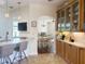 Bright kitchen with breakfast bar and display cabinets, seamlessly connecting to dining and living areas at 1930 Farmington Ct, Clermont, FL 34711
