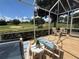Relaxing screened-in lanai offers golf course views, comfortable seating, and a tranquil atmosphere at 1930 Farmington Ct, Clermont, FL 34711