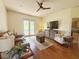 Inviting living room boasts hardwood floors, comfortable seating, and a view of the backyard at 1930 Farmington Ct, Clermont, FL 34711
