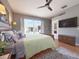 Cozy bedroom features ceiling fan, dresser, and sliding glass doors leading to the outdoor patio at 1930 Farmington Ct, Clermont, FL 34711