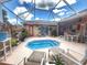 Private backyard oasis features a sparkling pool, lounge chairs, and lush landscaping at 1930 Farmington Ct, Clermont, FL 34711