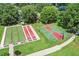Aerial view of the community sports courts for bocce ball and basketball on lush grounds at 1930 Farmington Ct, Clermont, FL 34711