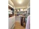Organized walk-in closet featuring white shelving and drawers, maximizing storage space for clothing and accessories at 1930 Farmington Ct, Clermont, FL 34711