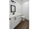 Bright bathroom with white vanity, dark hardware, and a modern sink at 2 Pine Terrace Way, Ocala, FL 34472