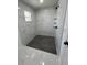 Bathroom featuring tiled shower with black fixtures and decorative accents at 2 Pine Terrace Way, Ocala, FL 34472