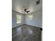 Comfortable bedroom featuring wood-look floors and two windows offering plenty of natural light at 2 Pine Terrace Way, Ocala, FL 34472