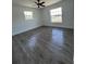 Cozy bedroom featuring wood-look floors and two windows offering plenty of natural light at 2 Pine Terrace Way, Ocala, FL 34472