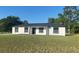 Charming single-story home featuring stucco siding, black trim, and a well-manicured lawn at 2 Pine Terrace Way, Ocala, FL 34472