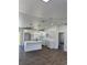 Bright, open kitchen features white cabinets, a center island, and modern finishes and fixtures at 2 Pine Terrace Way, Ocala, FL 34472