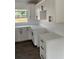 Modern kitchen featuring white cabinets, countertops, and sleek hardware and fixtures at 2 Pine Terrace Way, Ocala, FL 34472