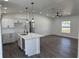 Open-concept living room with kitchen, center island, and modern finishes and fixtures at 2 Pine Terrace Way, Ocala, FL 34472