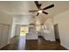 Open-concept living room features modern ceiling fan, kitchen with island, and hardwood floors at 2 Pine Terrace Way, Ocala, FL 34472
