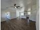 Open-concept living room featuring white walls, modern ceiling fan, and wood-look flooring at 2 Pine Terrace Way, Ocala, FL 34472