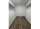 Walk-in closet featuring wood-look floors and ample storage space with white racks at 2 Pine Terrace Way, Ocala, FL 34472