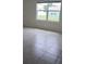 Bright bedroom with tile flooring and a large window providing ample natural light at 2106 Elio Ridge Dr, Zellwood, FL 32798