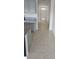 Open hallway with tile flooring, offering easy access to the kitchen and front door at 2106 Elio Ridge Dr, Zellwood, FL 32798