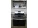 Modern stainless steel oven and microwave combination with granite countertops, offering a stylish look at 2106 Elio Ridge Dr, Zellwood, FL 32798
