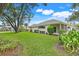 Back view of a home with verdant landscaping, trees and stop sign at 21226 Royal St Georges Ln, Leesburg, FL 34748