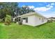 Well-maintained home exterior surrounded by lush landscaping and a green lawn at 21226 Royal St Georges Ln, Leesburg, FL 34748